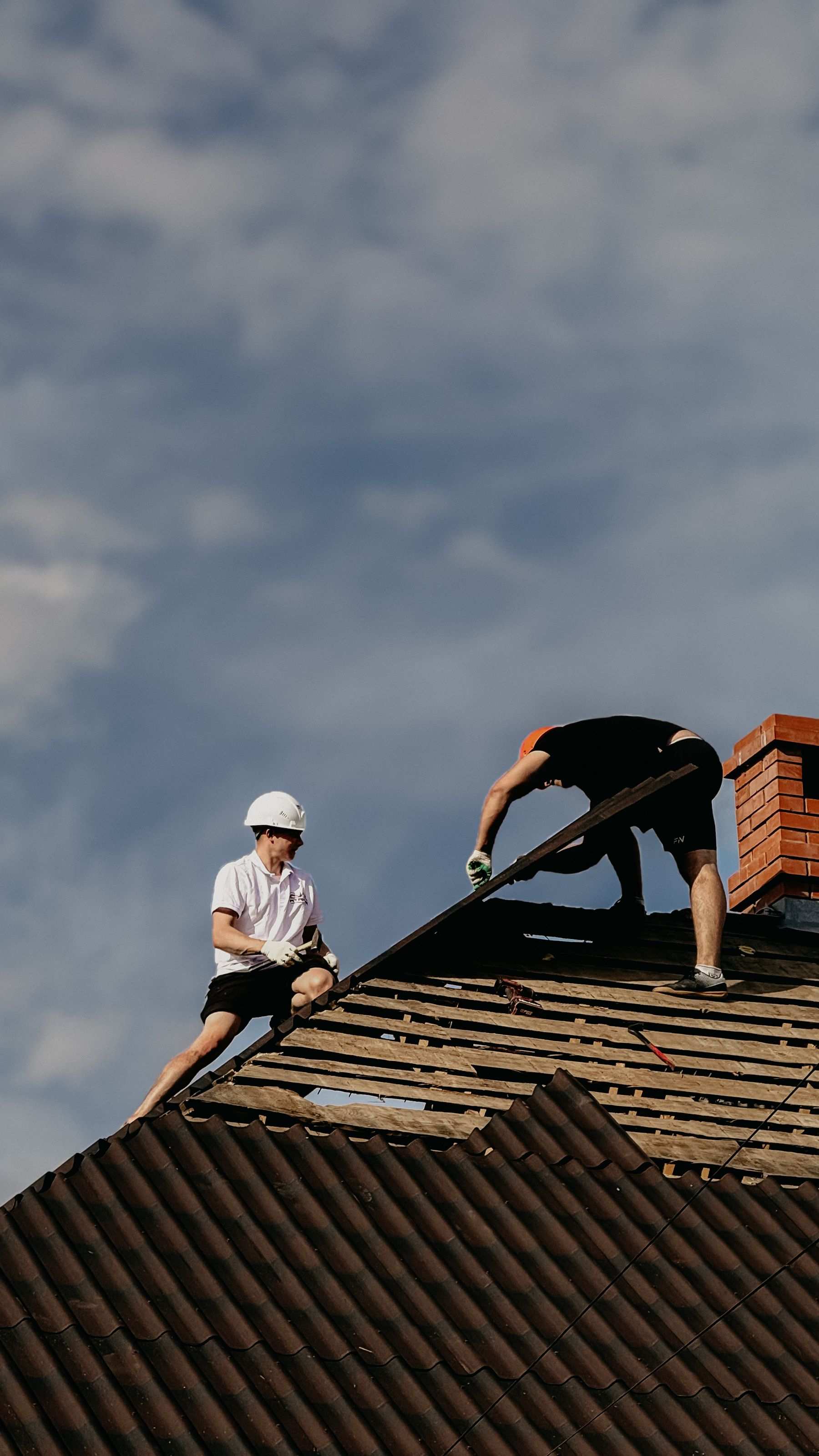 Roofers repairing a roof